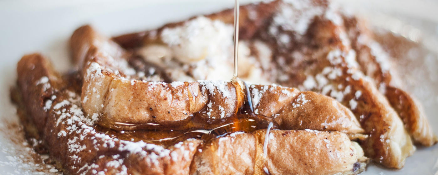 Cinnamon french toast with a syrup drizzle.