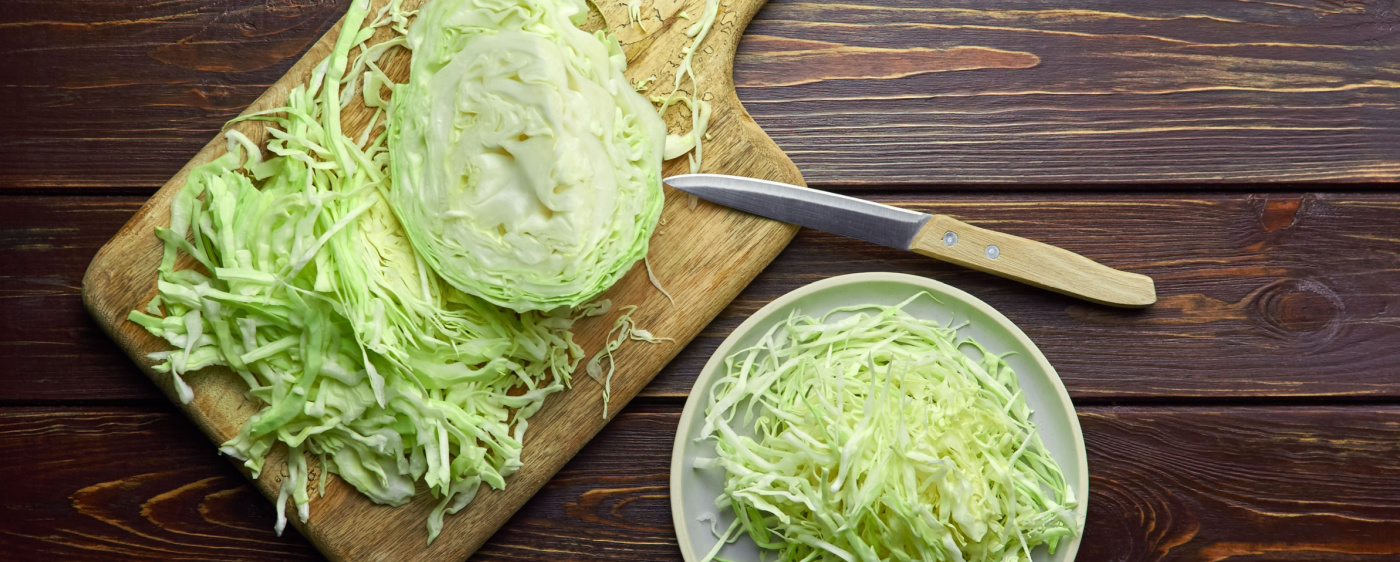 Cabbage being cut up for apple coleslaw.