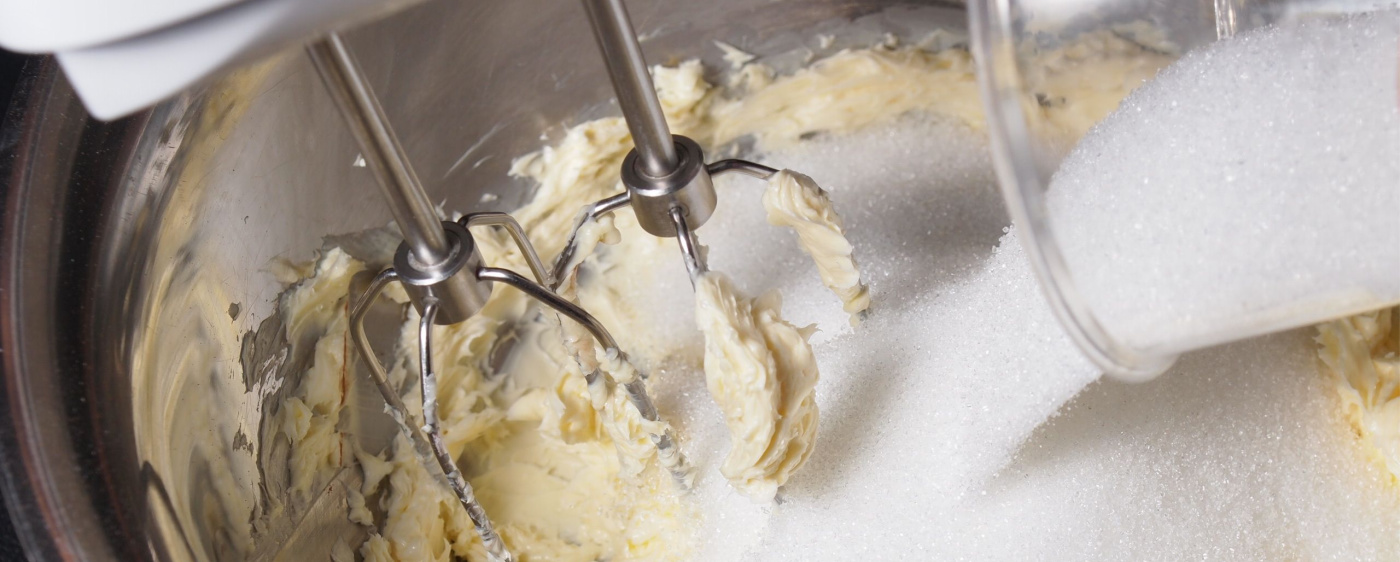 Mixing edible cookie dough in a standing mixer.