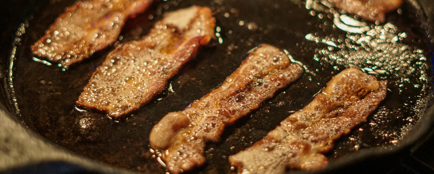 Bacon cooking in a skillet for Cottage Quiche.