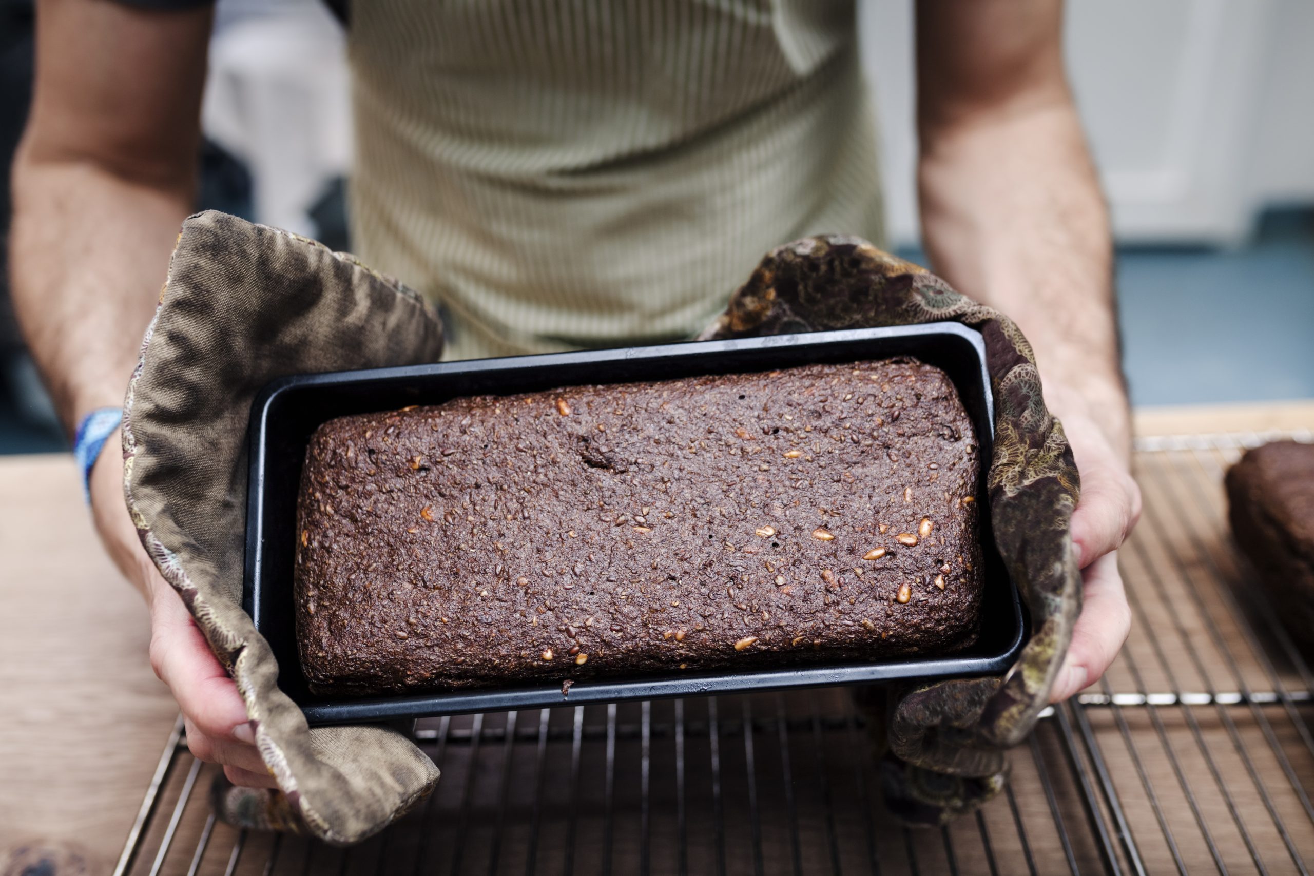 Rye bread straight out of the oven in a loaf pan.