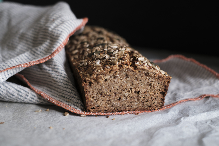 Rye bread loaf cooling down with the end cut off.