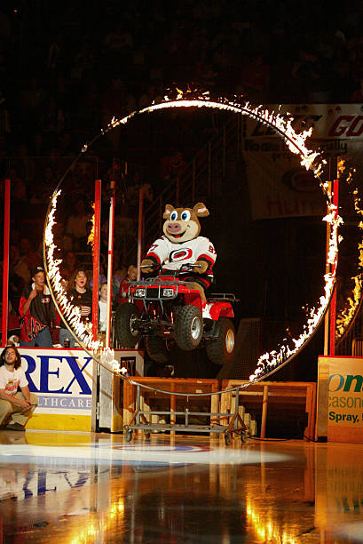 Mascot Stormy of the Carolina Hurricanes drives an ATV through a ring of fire during game two of the Stanley Cup playoffs against the New Jersey...