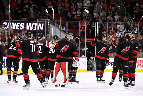 The Carolina Hurricanes celebrate with their traditional "Storm Surge" after a win against the Edmonton Oilers at PNC Arena on February 27, 2022 in...