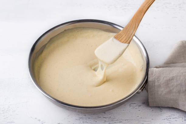 making pasta cheese sauce, step by step, diy. step 10. ready sauce in a frying pan - batter in saucepan stock pictures, royalty-free photos & images