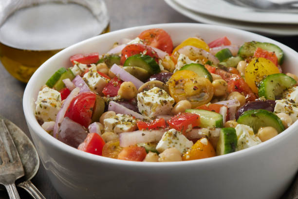 greek salad - greek chickpea salad stock pictures, royalty-free photos & images