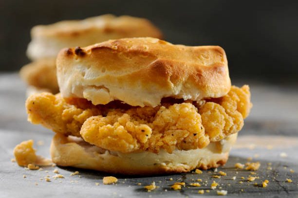 fried chicken sandwich on a biscuit - chicken strips and biscuit stock pictures, royalty-free photos & images