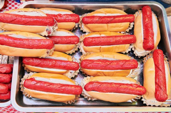 a tray with prepared hot dogs wrapped in bread - red hot dog stock pictures, royalty-free photos & images