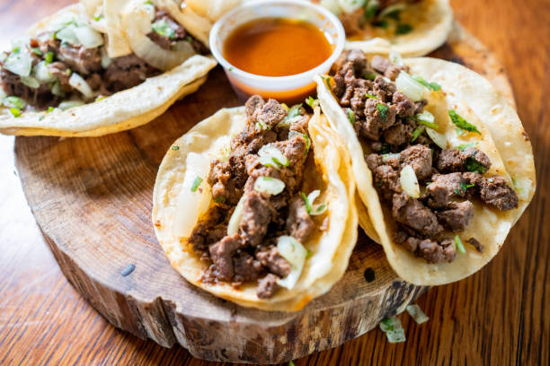 street tacos, a beloved staple of mexican cuisine, are typically made with birria or carne asada, served on a corn tortilla with onion, cilantro, and salsa - carne asada meat stock pictures, royalty-free photos & images