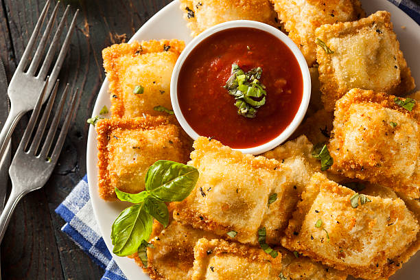 homemade fried ravioli with marinara sauce - fried ravioli stock pictures, royalty-free photos & images