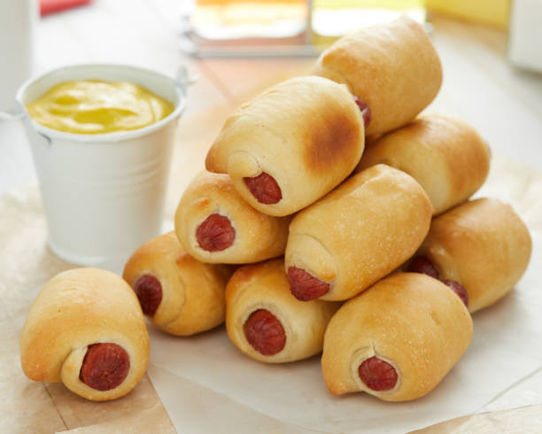 beef sausage wrapped in bagel dough - pigs in a blanket stock pictures, royalty-free photos & images