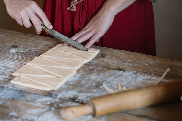 close-up of woman preparing dough for croissants - crescent roll dough stock pictures, royalty-free photos & images