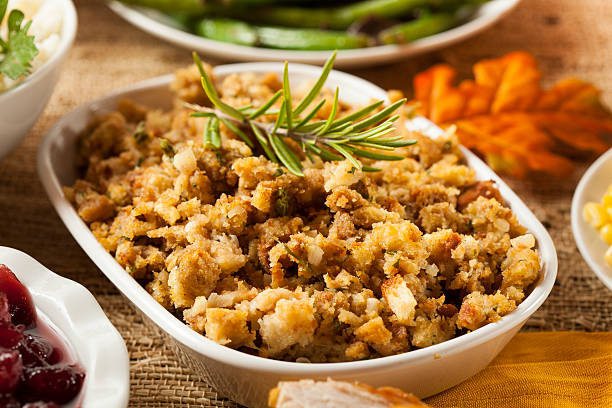 homemade thanksgiving stuffing in a white bowl - thanksgiving stuffing stock pictures, royalty-free photos & images