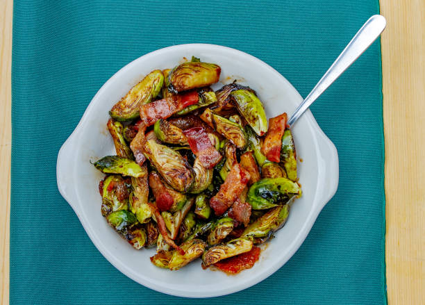 brussel sprouts and bacon appetizer dish - brussels sprouts and bacon stock pictures, royalty-free photos & images