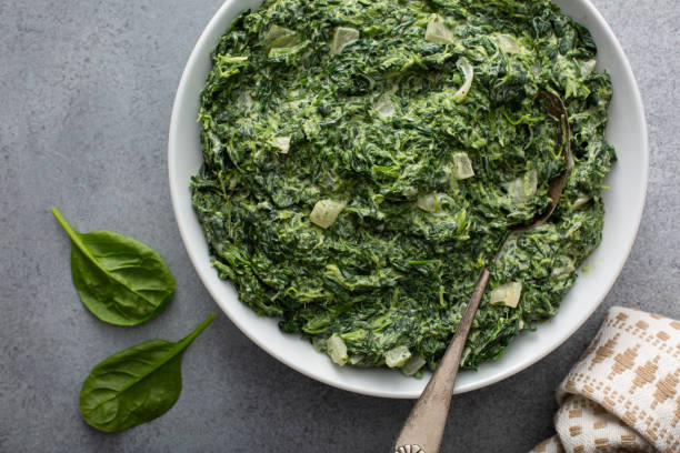 homemade creamed spinach in a bowl - creamy spinach side stock pictures, royalty-free photos & images