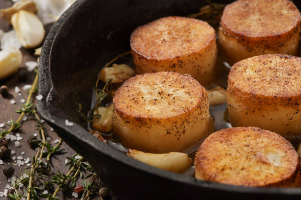 fondant aka melting potatoes in a garlic and thyme butter - melting potatoes stock pictures, royalty-free photos & images