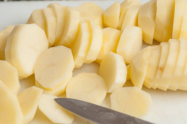 peeled potatoes series 01 - cutting potatoes stock pictures, royalty-free photos & images