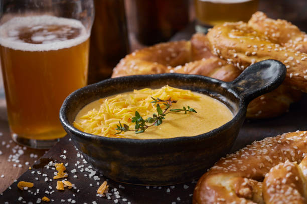 beer cheese sauce with soft pretzels - beer cheesde stock pictures, royalty-free photos & images