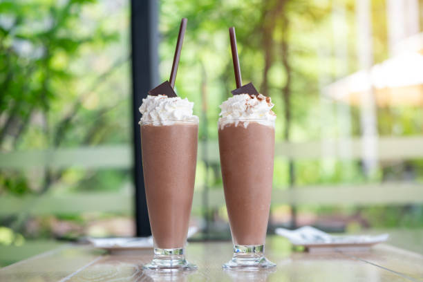 a fresh glass of ice milk chocolate on top whipped cream, sweet cocoa ice in beautiful glass sweet dessert already for drink on a wooden. chocolate home made for children. - milkshake chocolate stock pictures, royalty-free photos & images