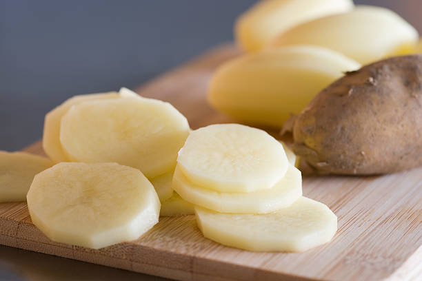 slices of raw potato - potato skin bites stock pictures, royalty-free photos & images