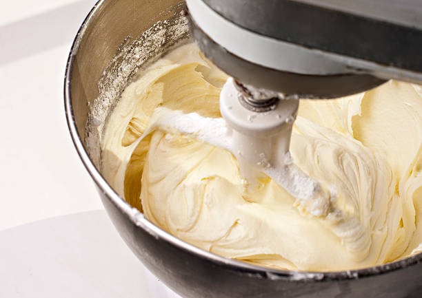 mixer beating yellow cake icing - cream cheese icing stock pictures, royalty-free photos & images