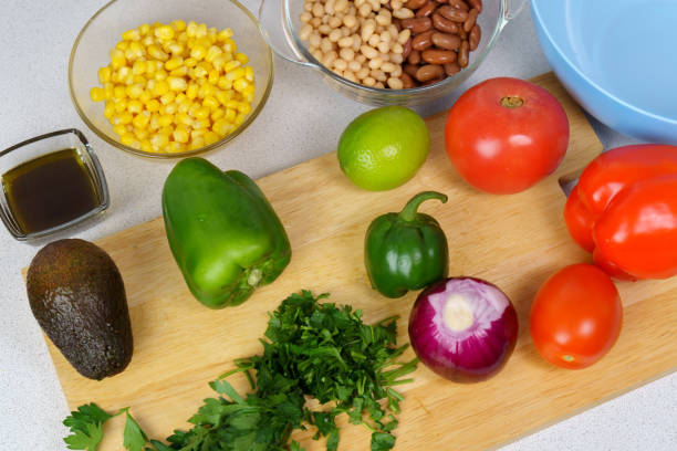 cowboy caviar, texas caviar corn, beans, tomatoes, avocado, lime served with nachos chips corn. raw foods, ingredients - texas caviar stock pictures, royalty-free photos & images