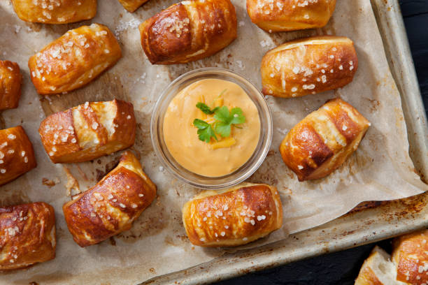 soft pretzel bites with a spicy, cheesy salsa con queso dip - soft pretzel bite stock pictures, royalty-free photos & images