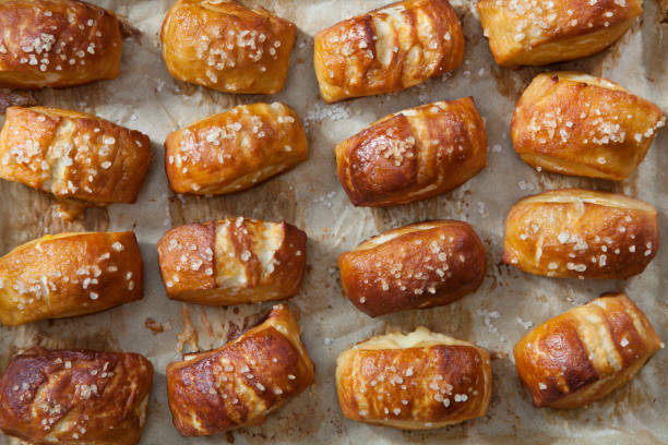 soft pretzel bites on a baking tray - soft pretzel bite stock pictures, royalty-free photos & images