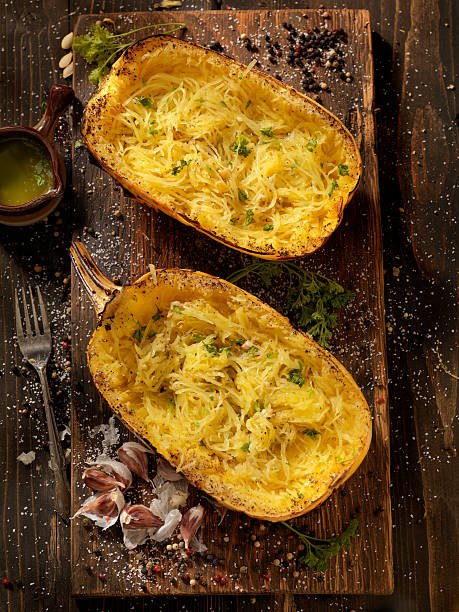 roasted spaghetti squash with garlic herb butter - feta spaghetti squash stock pictures, royalty-free photos & images