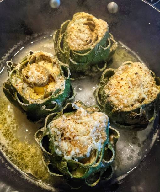 stuffed artichokes cooking - stuffed artichokes stock pictures, royalty-free photos & images