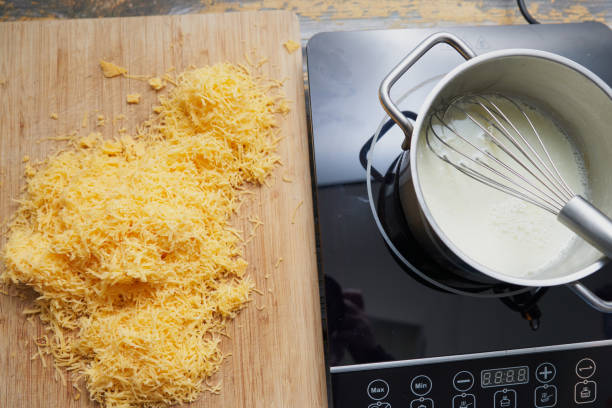 cheddar sauce preparation - making mac n cheese stock pictures, royalty-free photos & images