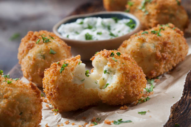 creamy mashed potato croquettes with cheese and sour cream dip - arancini balls stock pictures, royalty-free photos & images