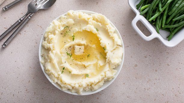 mashed potatoes in a serving bowl, traditional side dish for dinner or celebration - creamy mashed potatoes stock pictures, royalty-free photos & images