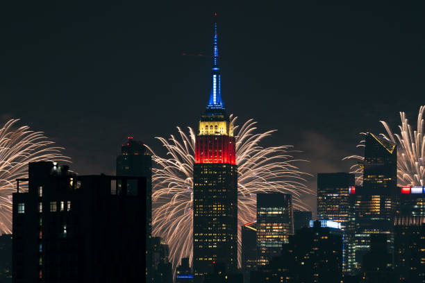 The Macy's 4th Of July fireworks show lights up the night sky as a backdrop to the Empire State Building on July 4, 2024 in New York City. The annual...