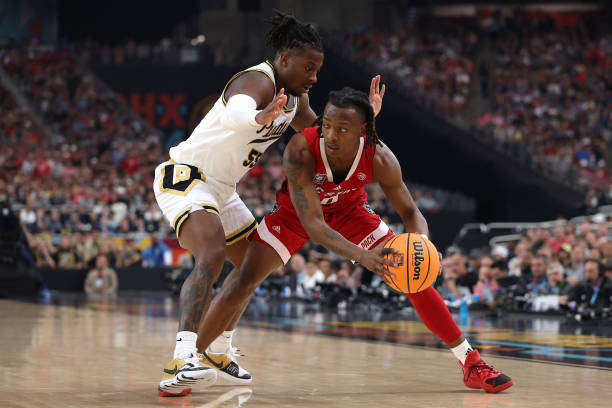 Horne of the North Carolina State Wolfpack handles the ball while being guarded by Lance Jones of the Purdue Boilermakers in the second half in the...