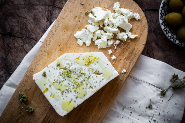 feta cheese on cutting board - feta and olive oil stock pictures, royalty-free photos & images