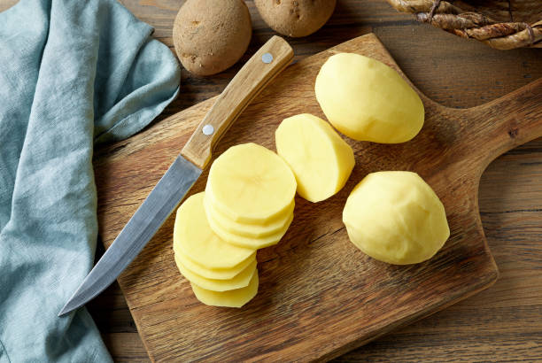 fresh raw peeled potatoes - slicing potatoes stock pictures, royalty-free photos & images