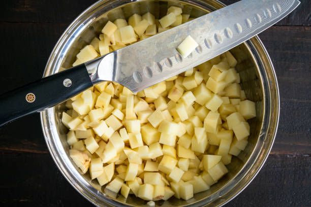 diced russet potatoes and a chef's knife - potato cube stock pictures, royalty-free photos & images