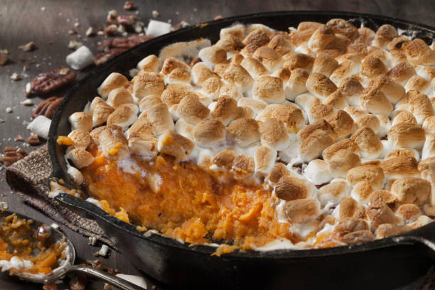 sweet potato casserole with pecans and marshmallows - sweet potato casserole stock pictures, royalty-free photos & images