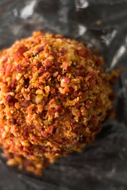 bacon cheese ball on a black marble background. - bacon and cheese ball stock pictures, royalty-free photos & images