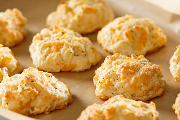 cheddar cheese biscuits fresh from the oven - cheddar biscuits stock pictures, royalty-free photos & images