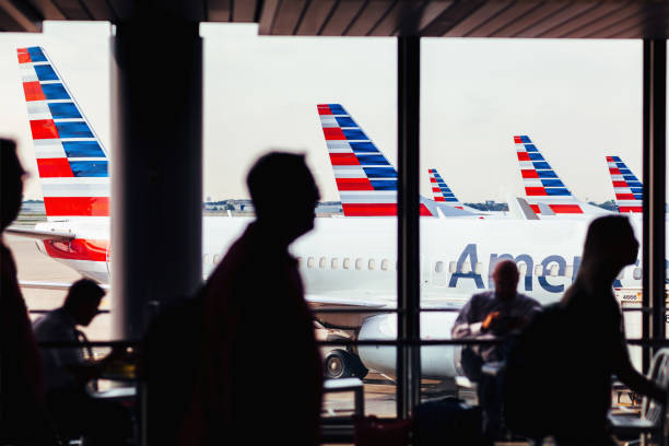 american airlines fleet of airplanes with passengers at o'hare airport - american airlines stock pictures, royalty-free photos & images