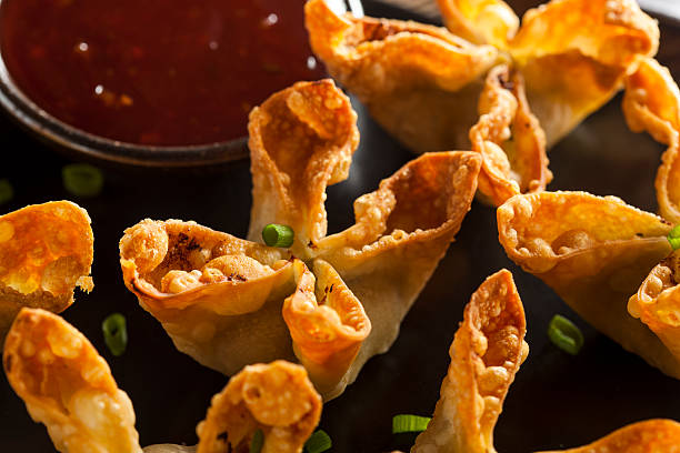 asian crab rangoons with sweet and sour sauce - crab rangoon stock pictures, royalty-free photos & images