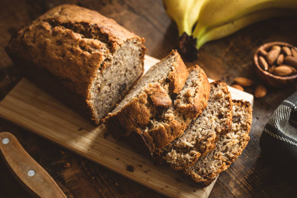 banana bread loaf on wooden table - banana bread stock pictures, royalty-free photos & images