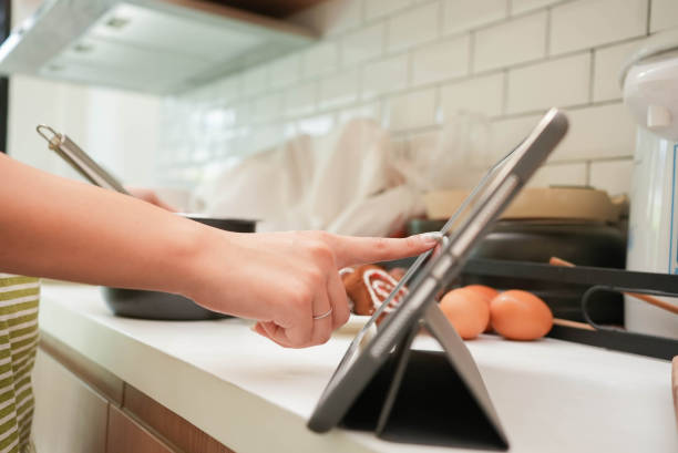 close up woman hand touchscreen on tablet to learn about bakery receipt program to practice from streaming website and cooking online course for healthy living concept - learning to cook social media stock pictures, royalty-free photos & images