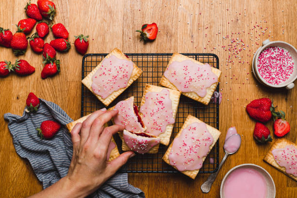 woman preparing jam filled pastry tarts - homemade pop tarts stock pictures, royalty-free photos & images