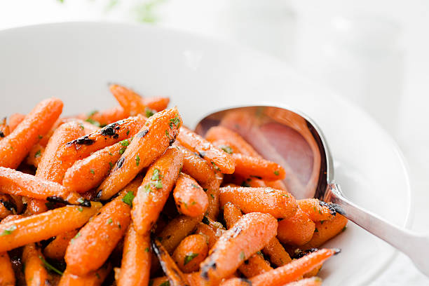 grilled honey glazed baby carrots close up - glazed carrots stock pictures, royalty-free photos & images