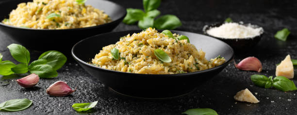 creamy garlic and parmesan orzo pasta with lemon zest and parsley - orzo with parmesan & basil stock pictures, royalty-free photos & images